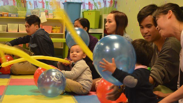 Children and parents play with balloons at an HKYTA session