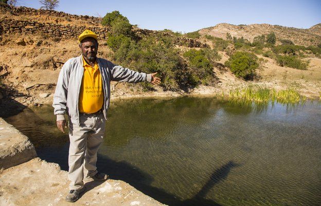 Village chief and head motivator Aba Hawi shows off one of the 18 dams built by communal labour on what was once a flash-flood gully.
