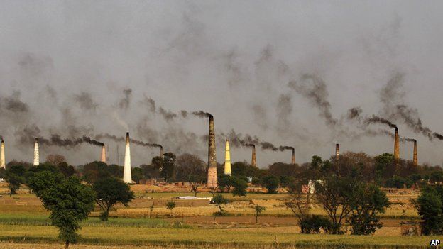 Smoke rises from brick kiln chimneys on the outskirts of Delhi