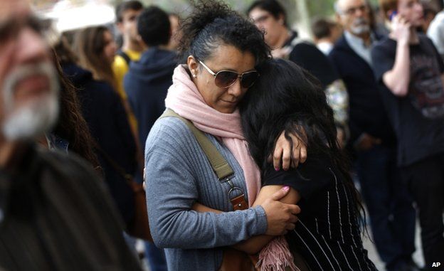 A pupil is hugged outside Joan Fuster institute (20 April)