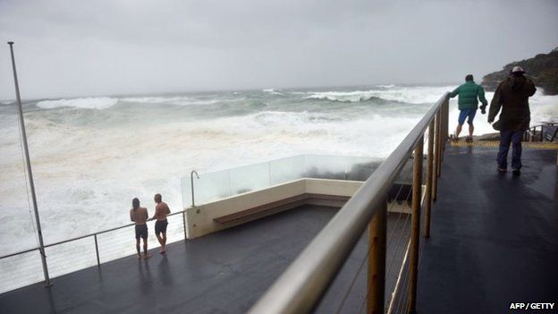 Visitors look out at heavy seas whipped up by strong winds at Bondi Beach in Sydney on 21 April 2015.