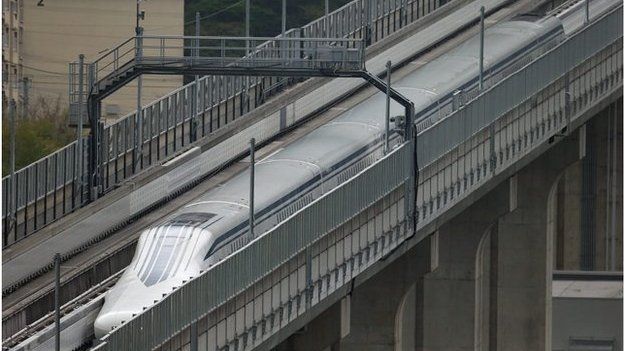 A handout picture provided by the Central Japan Railway Co shows a maglev train speeding on an experimental track in Yamanashi Prefecture, central Japan, 21 April 2015