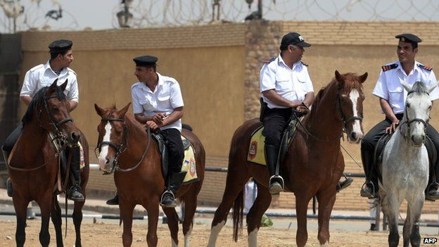 Egyptian mounted security stand guard outside the police academy during the trial of Egypt"s former Islamist president Mohamed Morsi, in the capital, Cairo, on April 21, 2015