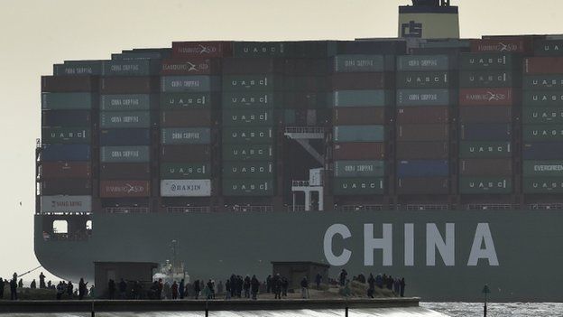 Onlookers watch from a harbour wall as the largest container ship in world, CSCL Globe, docks during its maiden voyage, at the port of Felixstowe in south east England
