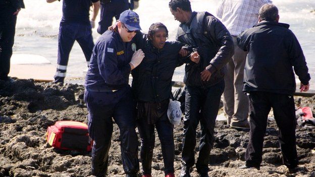 Greek coast guards help a migrant woman rescued after a boat carrying migrants sank off the island of Rhodes, south-eastern Greece, on 20 April