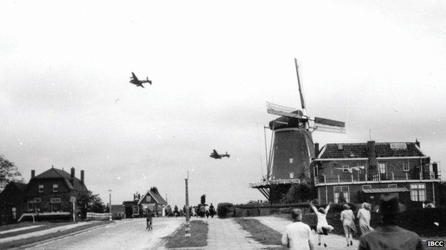 Lancaster bombers flying past a windmill