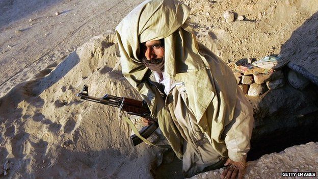 A Bugti militiaman emerges from an underground bunker after a mortar attack on January 25, 2006 on Dera Bugti in the Pakistani province of Balochistan.