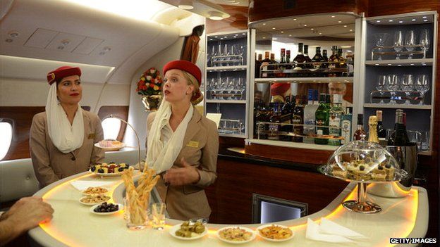 Flight attendants at the bar of the executive suite cabin of an Emirates Airbus A380