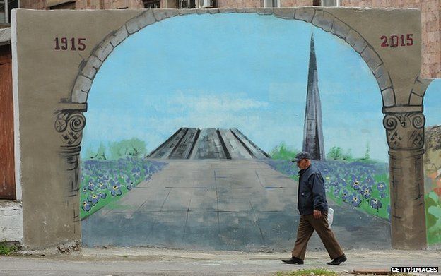 Man walks past mural in Yerevan depicting Armenia's genocide memorial (22 April)