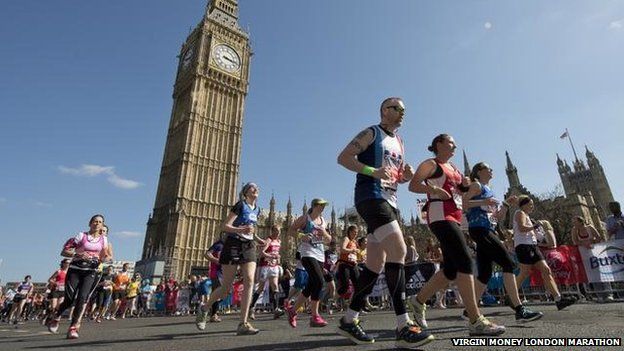 Marathon runners pass Big Ben in London
