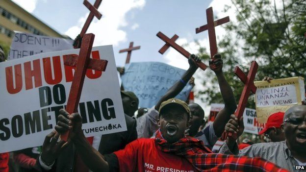 Demonstrators hold up painted crosses symbolizing 28 people who were killed in a recent attack on a bus in Mandera by Somalia's Islamist militant group al-Shabab, in protest against government and its failure to protect people in Nairobi, Kenya, 25 November 2014