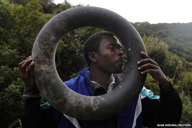 A migrant blows up an inner tyre