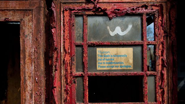 "Out of order" notice on derelict phone box