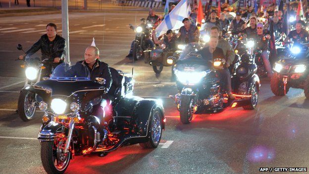 Russian Prime Minister Vladimir Putin (L) rides a motorbike as he takes part in the 16th annual motorbike festival held by "The Night Wolves" youth organisation in the southern Russian town of Novorossiysk, 29 August 2011