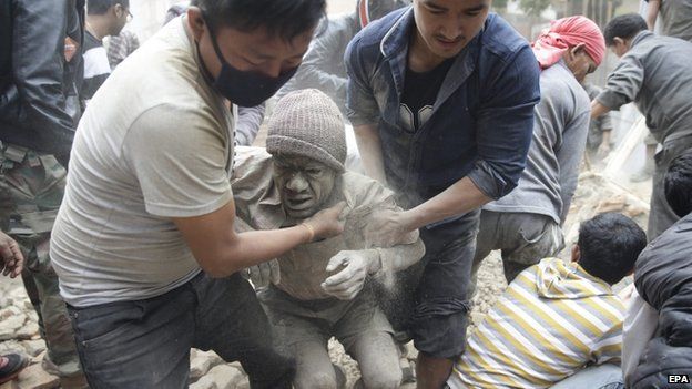 People free a man from the rubble of a destroyed building after an earthquake hit Nepal, in Kathmandu, Nepal, 25 April 2015
