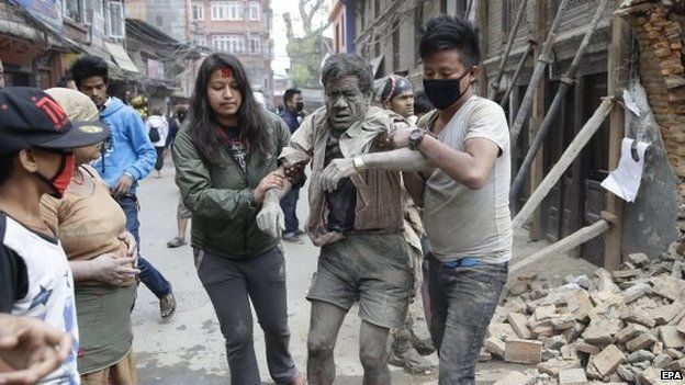 People free a man from the rubble of a destroyed building after an earthquake hit Nepal, in Kathmandu, Nepal, 25 April 2015.