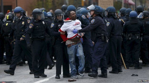 Police detain a protester at a rally to protest the death of Freddie Gray who died following an arrest in Baltimore, Maryland April 25, 2015.