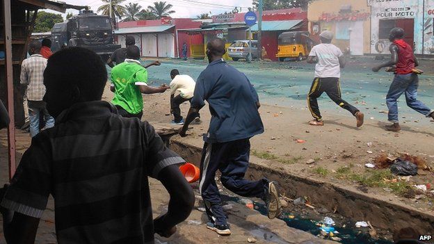 Protesters throw rocks during clashes with police in Cibitoke, north-western Burundi, on April 26, 2015