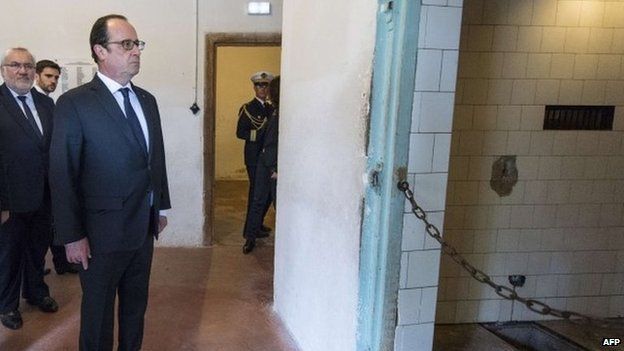 French President Francois Hollande looks at a gas chamber at the former Nazi concentration camp in Natzwieler-Struthof, eastern France, on 26 April 2015, on a day commemorating the Allied liberation of the last Nazi camps at the end of World War Two