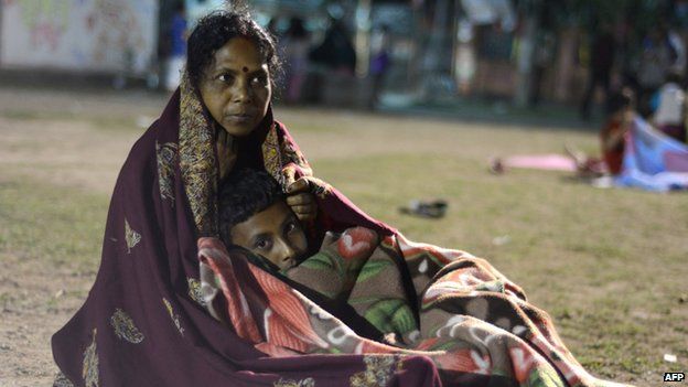 Indian residents rest and sleep in a football field in Siliguri on April 26, 2015 after a 7.8 magnitude earthquake hit the region on April 25 in Nepal.
