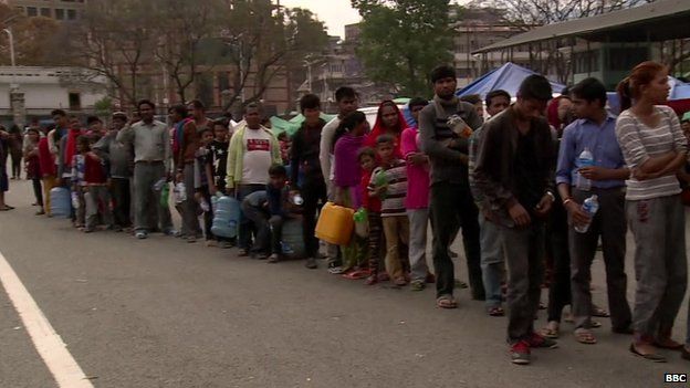People queue for water at camp in Kathmandu