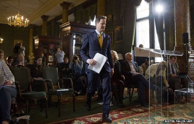 Nick Clegg prepares to address delegates on the economy at a press conference in London