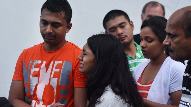 Brintha Sukumaran (2nd L), sister of Australian drug convict and death row prisoner Myuran Sukumaran, reacts as she holds on to her brother Chinthu Sukumaran (L) while Michael Chan (3rd L), brother of death row prisoner Andrew Chan looks on as the two families give statements to journalists in Cilacap following their final visit to Nusakambangan maximum security prison island on April 28, 2015