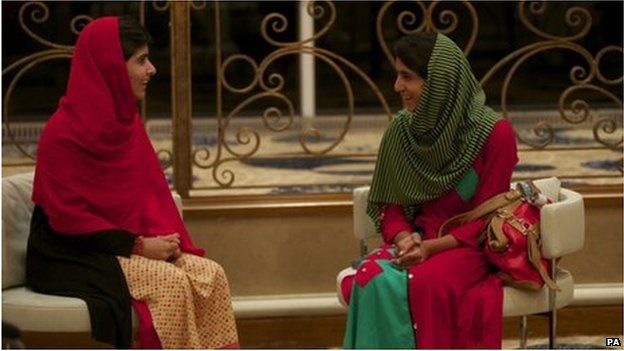 Malala Yousafzai (left) and Shazia Ramzan chat after meeting for the first time after the attack