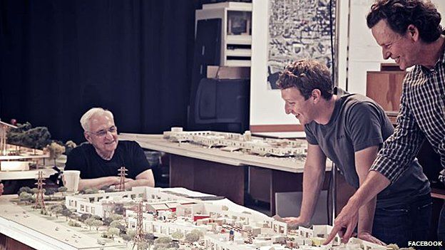 Facebook founder Mark Zuckerberg looks at a model of the new building with architect Frank Gehry