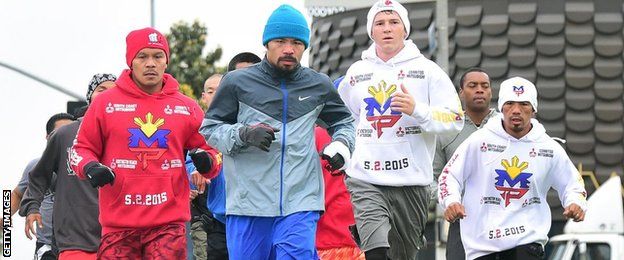 Pacquiao (centre) and support team on a morning jog