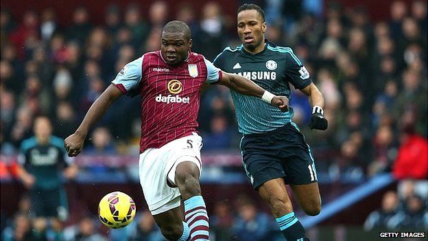 Jores Okore of Aston Villa battles for the ball with Didier Drogba of Chelsea