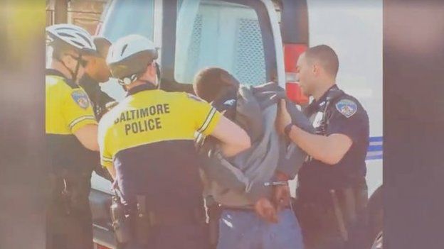 A still from amateur video footage that showed Gray being handcuffed and pushed into a police van