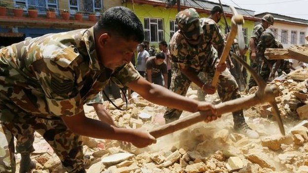 Nepalese soldiers work in the rubble of a collapsed house in the Manakamana village. Photo: 1 May 2015