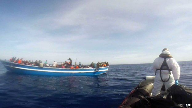 Video grab showing an Italian coastguard taking part in a rescue operation of a boat carrying 397 migrants on 2 May 2015, in the Mediterranean Sea (released by the Italian coastguard)