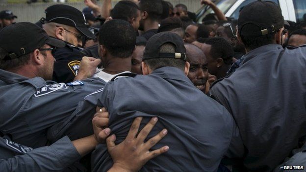 Israeli policemen push protesters, mainly whom are Israeli Jews of Ethiopian origin- Tel Aviv May 3, 2015.