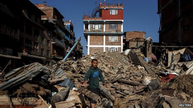 A local resident clears the rubble from his home which was destroyed after last week's earthquake in Bhaktapur, Nepal, May 4, 2015.