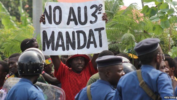A protester holds a placard as they demonstrate against the ruling CNDD-FDD party"s decision to allow Burundi President Pierre Nkurunziza to run for a third five-year term in office