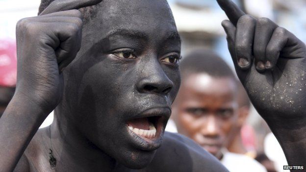 A protester with his face marked with black soot, participates in demonstrations in Burundi's capital Bujumbura, 6 May 2015