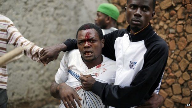 Jean Claude Niyonzima, a suspected member of the ruling party's Imbonerakure youth militia, is restrained as a mob gathers around his house, as protests continue against President Pierre Nkurunziza's decision to seek a third term in office in the Cibitoke district of Bujumbura, Burundi, 7 May 2015