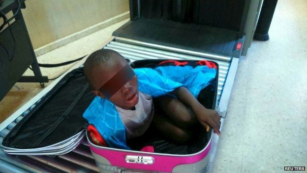 An eight-year-old boy is seen cramped inside a suitcase on a Spanish civil guard border security checkpoint between Morocco and Spain's North African enclave of Ceuta in this handout photo released May 8, 2015.