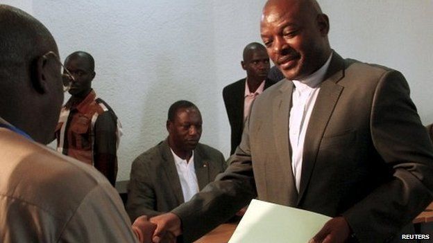 Burundian President Pierre Nkurunziza submits his documents as he registers to run for a third five-year term in office