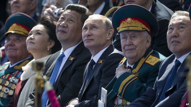 Russian President Vladimir Putin, centre, Chinese President Xi Jinping, third left, watching Victory Parade, with Xi's wife Peng Liyuan, second left, Kazakh President Nursultan Nazarbayev on the right