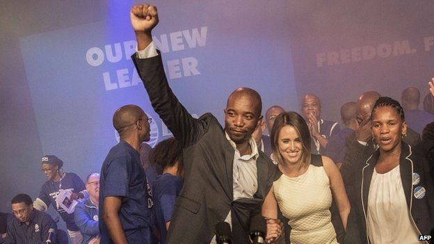 South Africa main opposition party Democratic Alliance newly elected Leader Musi Maimane (L) raises his fist as he celebrates his victory, on May 10, 2015 in Port Elizabeth, South Africa