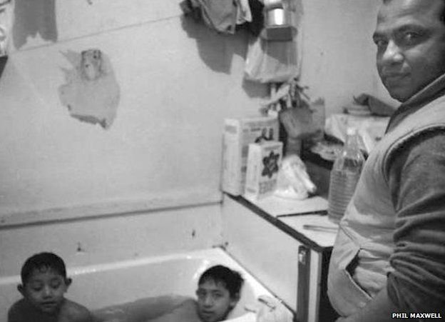 Children bathing in the kitchen in Holland Estate in the 80s