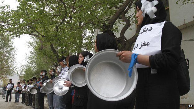 Afghans bang pots during an anti-government protest against the lack of progress in finding the kidnapped men in Kabul on 18 April 2015