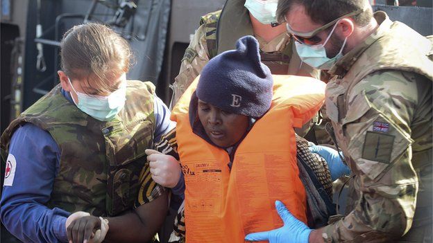 UK Royal Navy personnel help a migrant in Mediterranean, 7 May 15