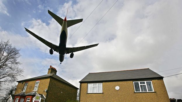 A plane comes into land over rooftops near Heathrow