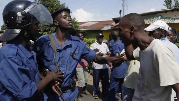 A demonstrator argues with police protesters march through the Musaga district of Bujumbura, in Burundi, Monday, 11 May 2015