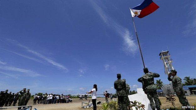 Filipino residents and soldiers conduct a flag raising ceremony during the visit of Armed Forces of the Philippines military chief General Gregorio Catapang in Pagasa Island (Thitu Island) at the Spratly group of islands in the South China Sea, west of Palawan, Philippines, May 11, 2015