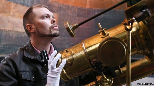 Astrophysicist Duane Hamacher with a telescope